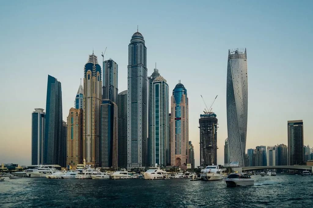 Dubai Marina towers rising above the water with yachts moored in front