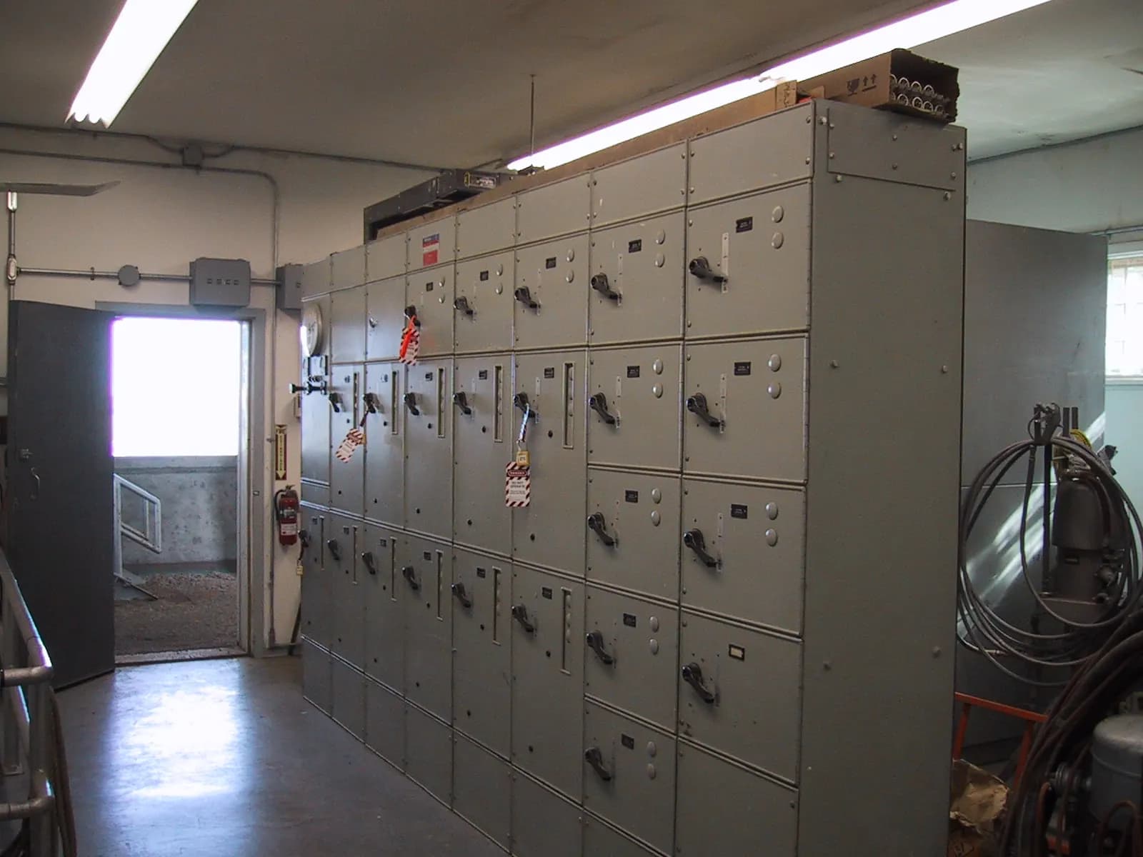 Row of grey motor control centre cabinets with breaker doors in an industrial electrical room