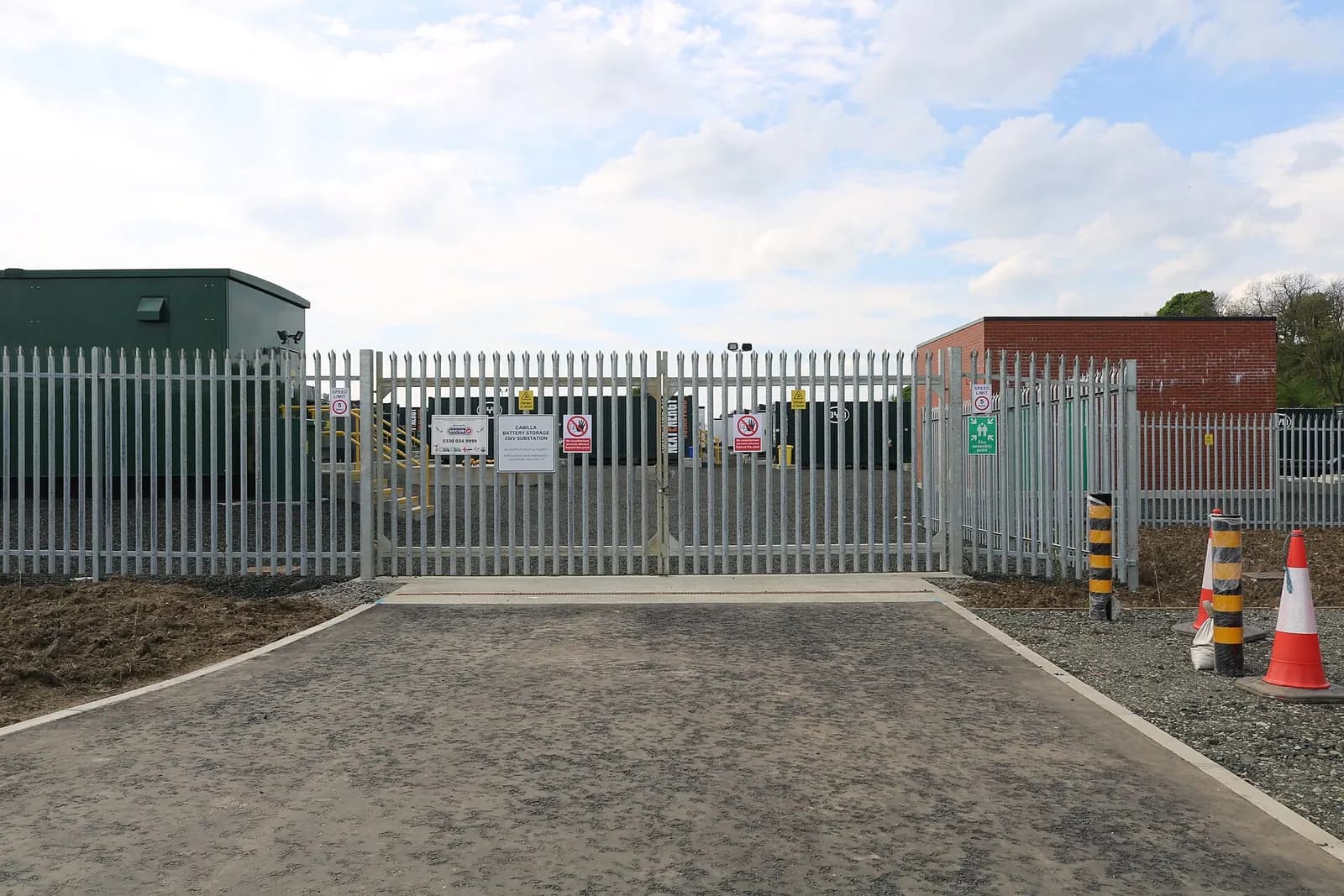Fenced entrance gate and access road at the Camilla battery storage facility in Fife, Scotland