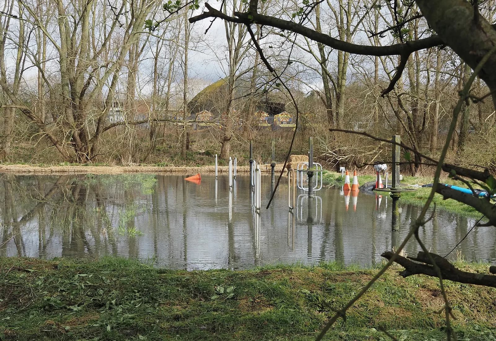 Storm tanks at Amersham under construction with fencing and flooded ground