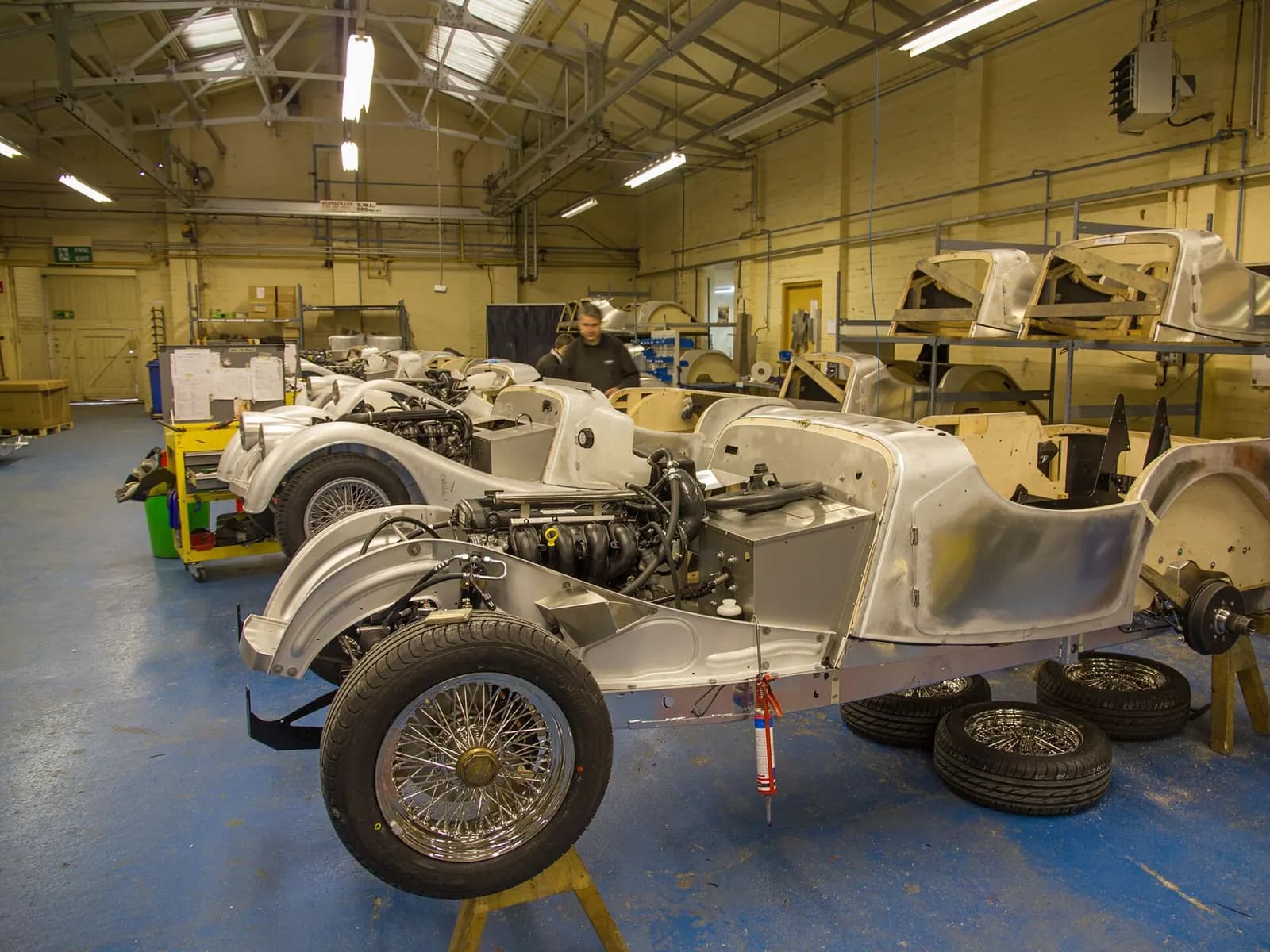 Car bodies on stands in the Morgan Motor Company factory workshop at Malvern