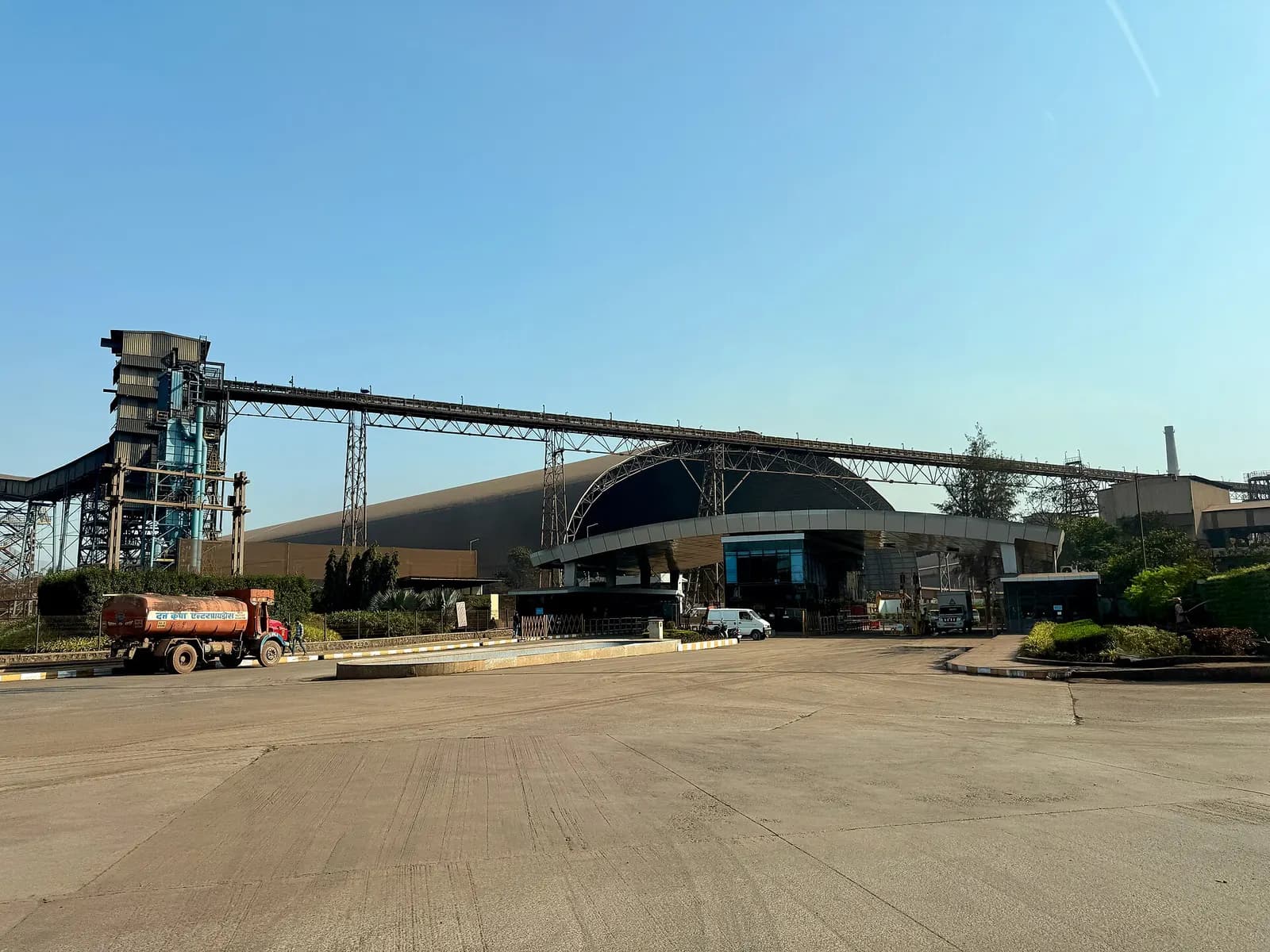 Conveyor gallery, transfer tower and large storage shed at the JSW Steel works in Dolvi, India.
