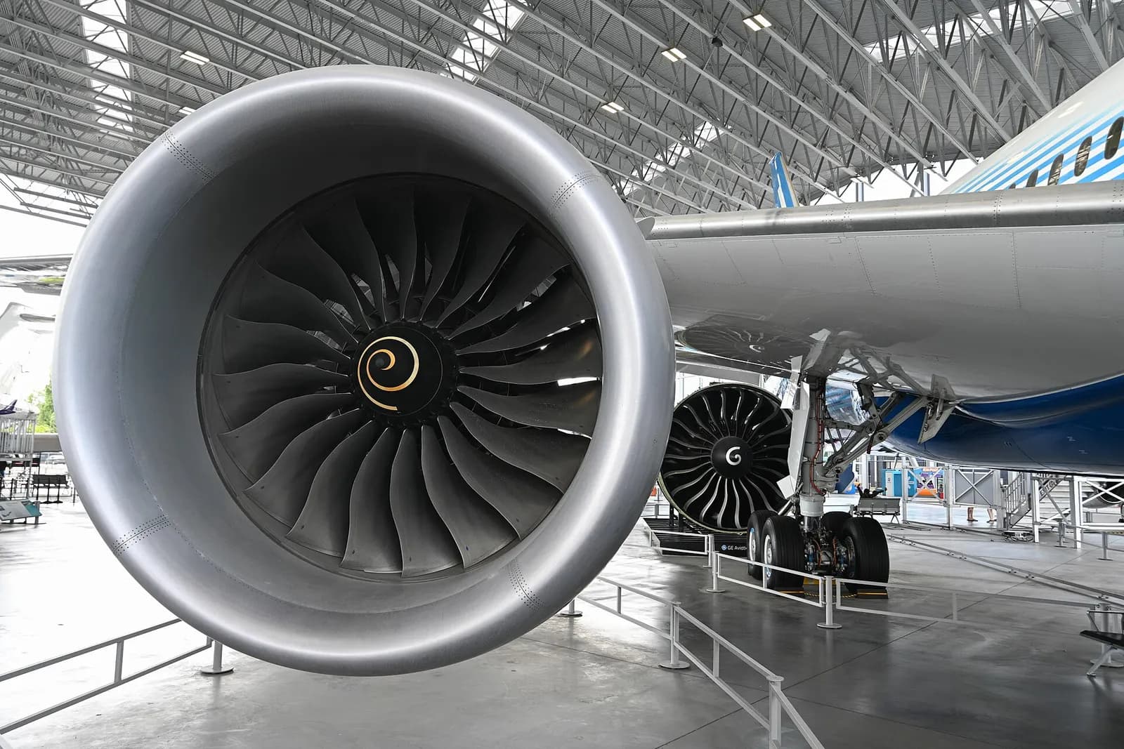 Front view of a Rolls-Royce Trent 1000 turbofan engine on a Boeing 787 Dreamliner inside a museum hangar.